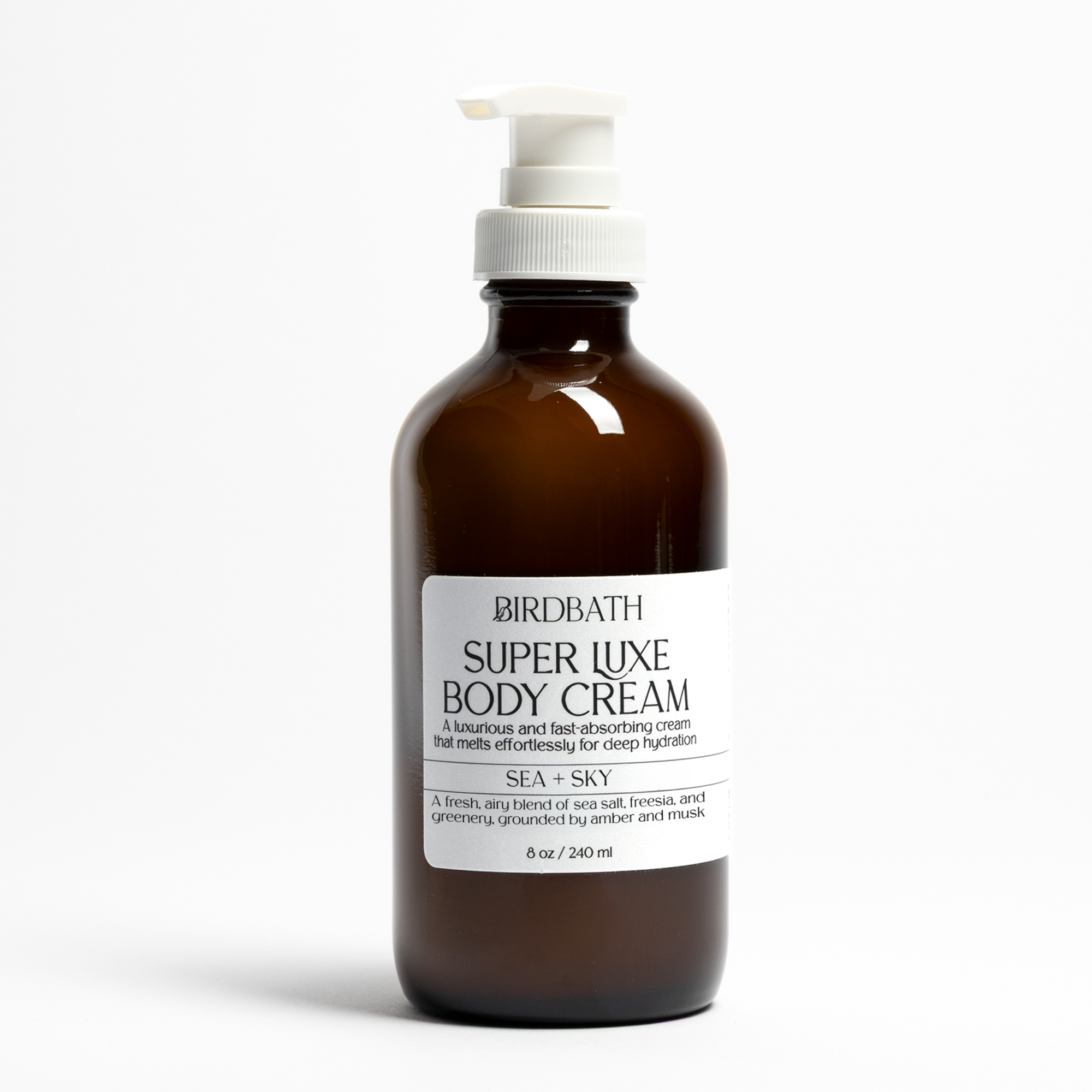 Amber bottle of Birdbath Sea + Sky Super Luxe Body Cream on a white background