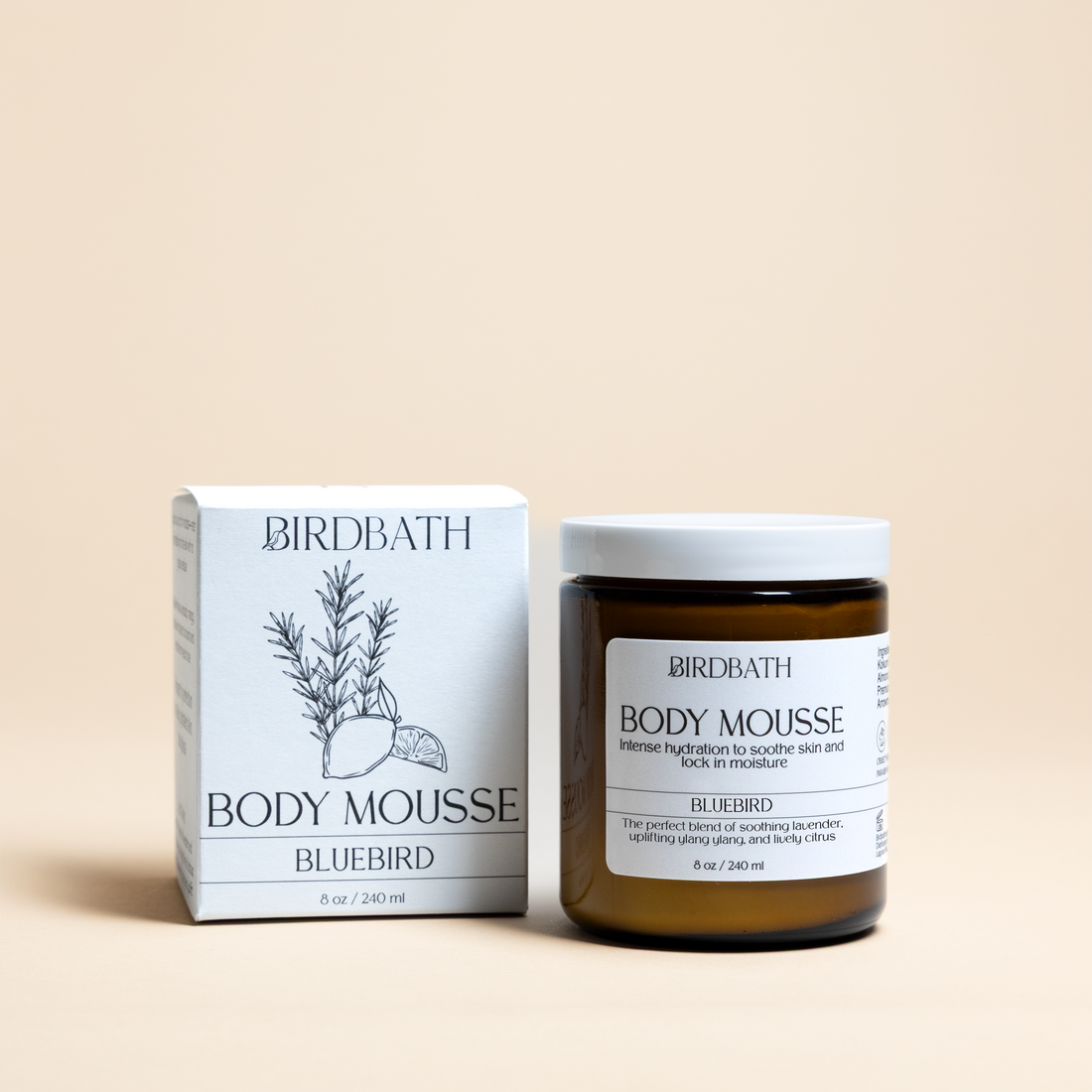Birdbath Bluebird Body Mousse jar with a white product box on a cream background.