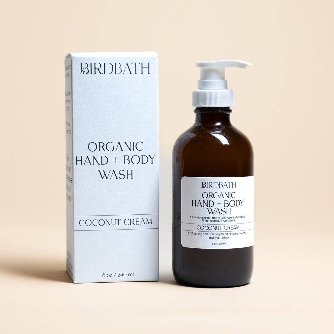Birdbath Coconut Cream Organic Hand + Body Wash bottle and packaging on a beige background