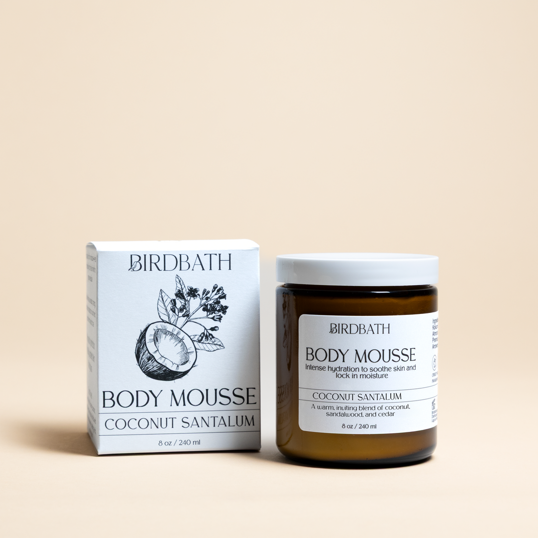 Birdbath Coconut Santalum Body Mousse jar with a white product box on a cream background.