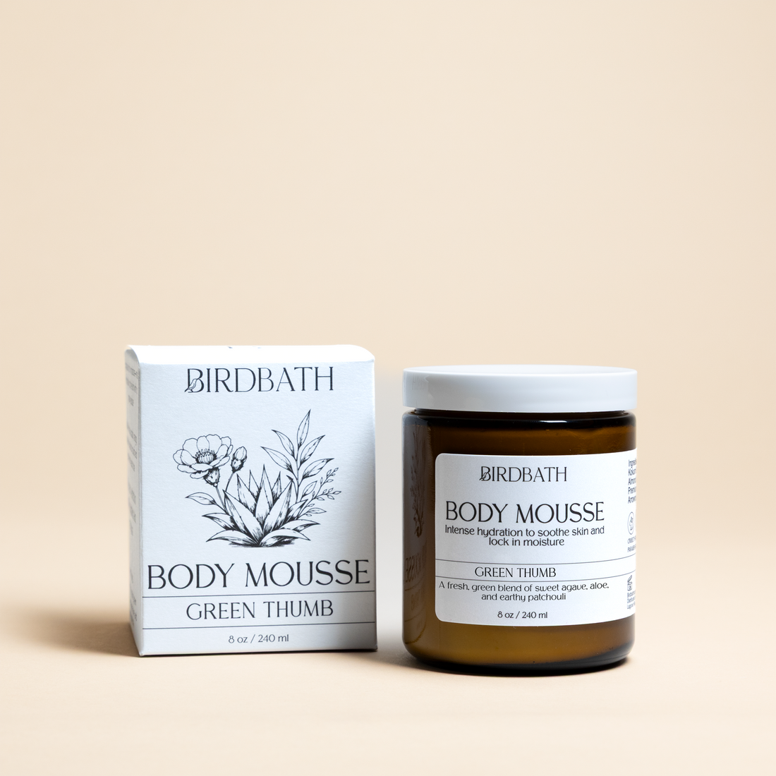 Birdbath Green Thumb Body Mousse jar with a white product box on a cream background.