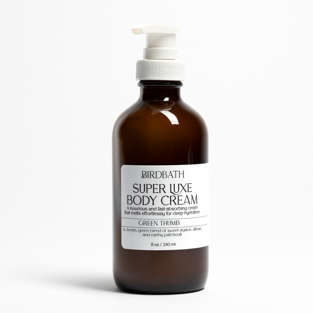Amber bottle of Birdbath Green Thumb Super Luxe Body Cream on a white background