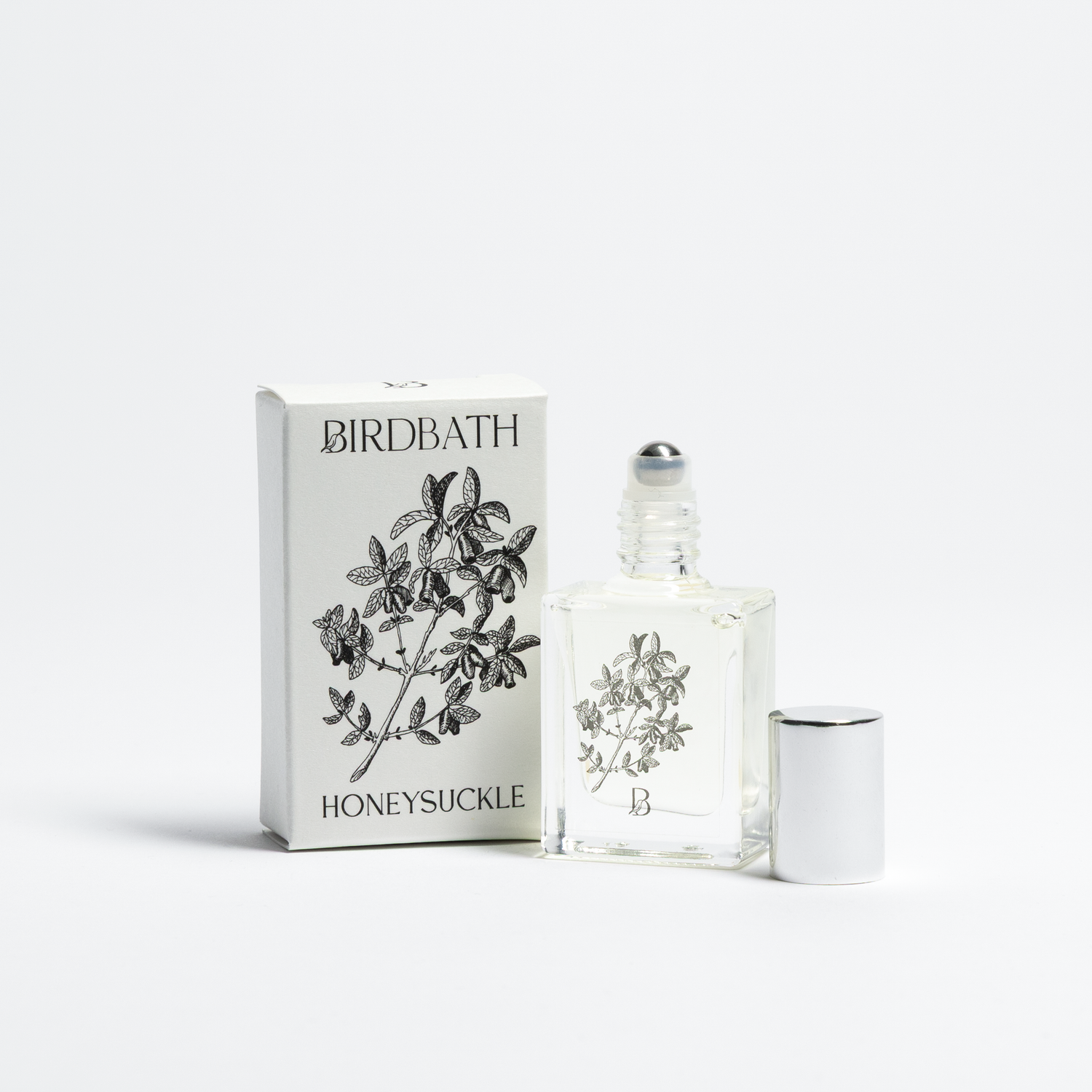 Birdbath Honeysuckle perfume bottle and packaging on a white background