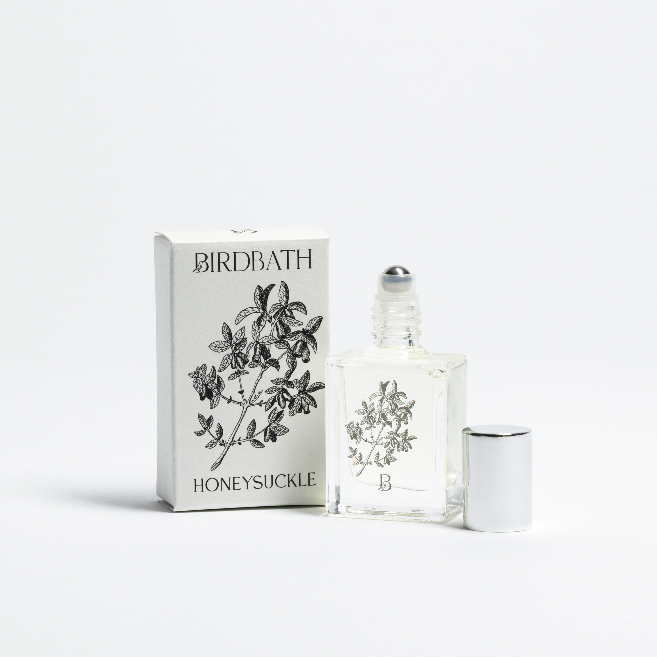 Birdbath Honeysuckle perfume bottle and packaging on a white background