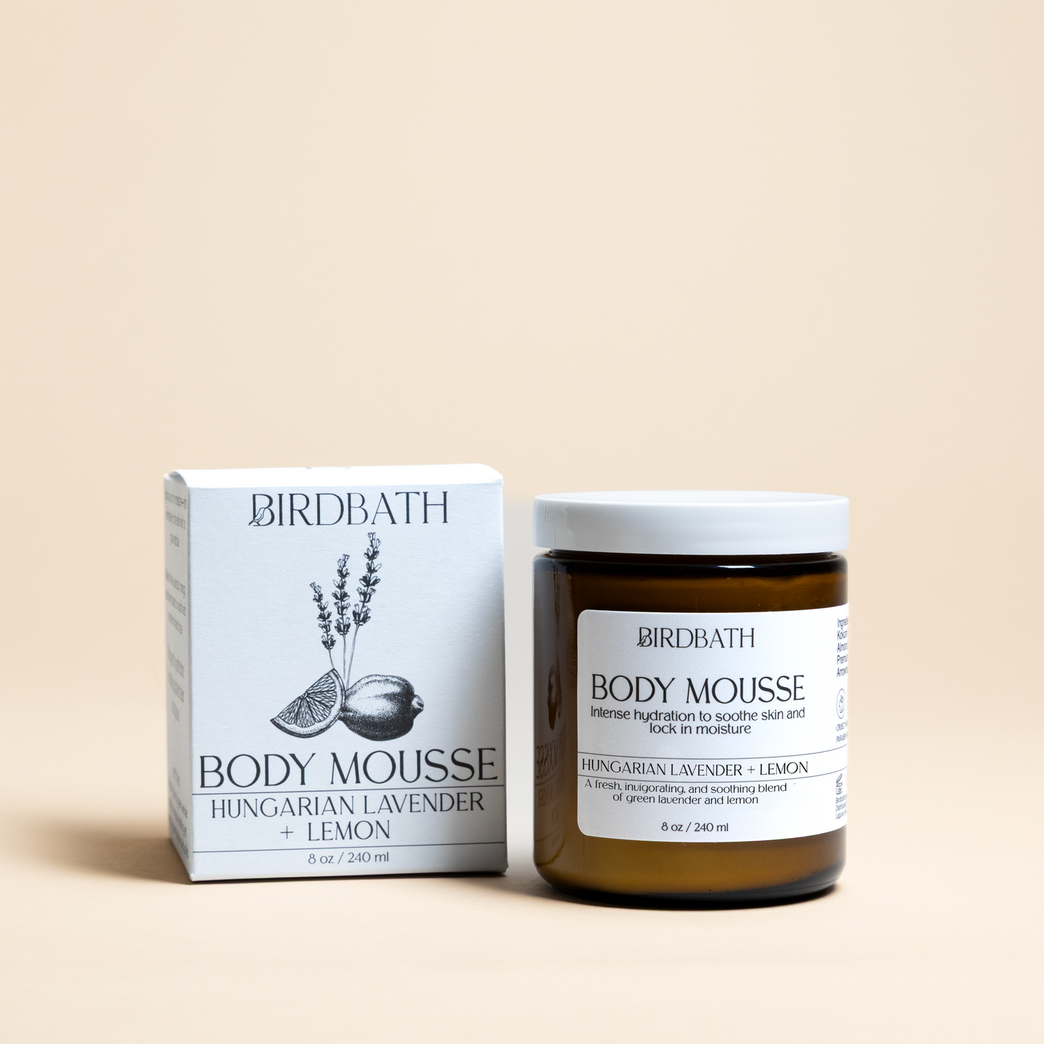 Birdbath Hungarian lavender + lemon Body Mousse jar with a white product box on a cream background.