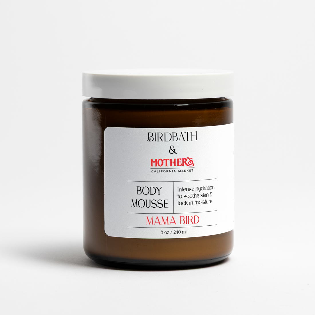 Birdbath Mama Bird Body Mousse in an amber jar on a white background.
