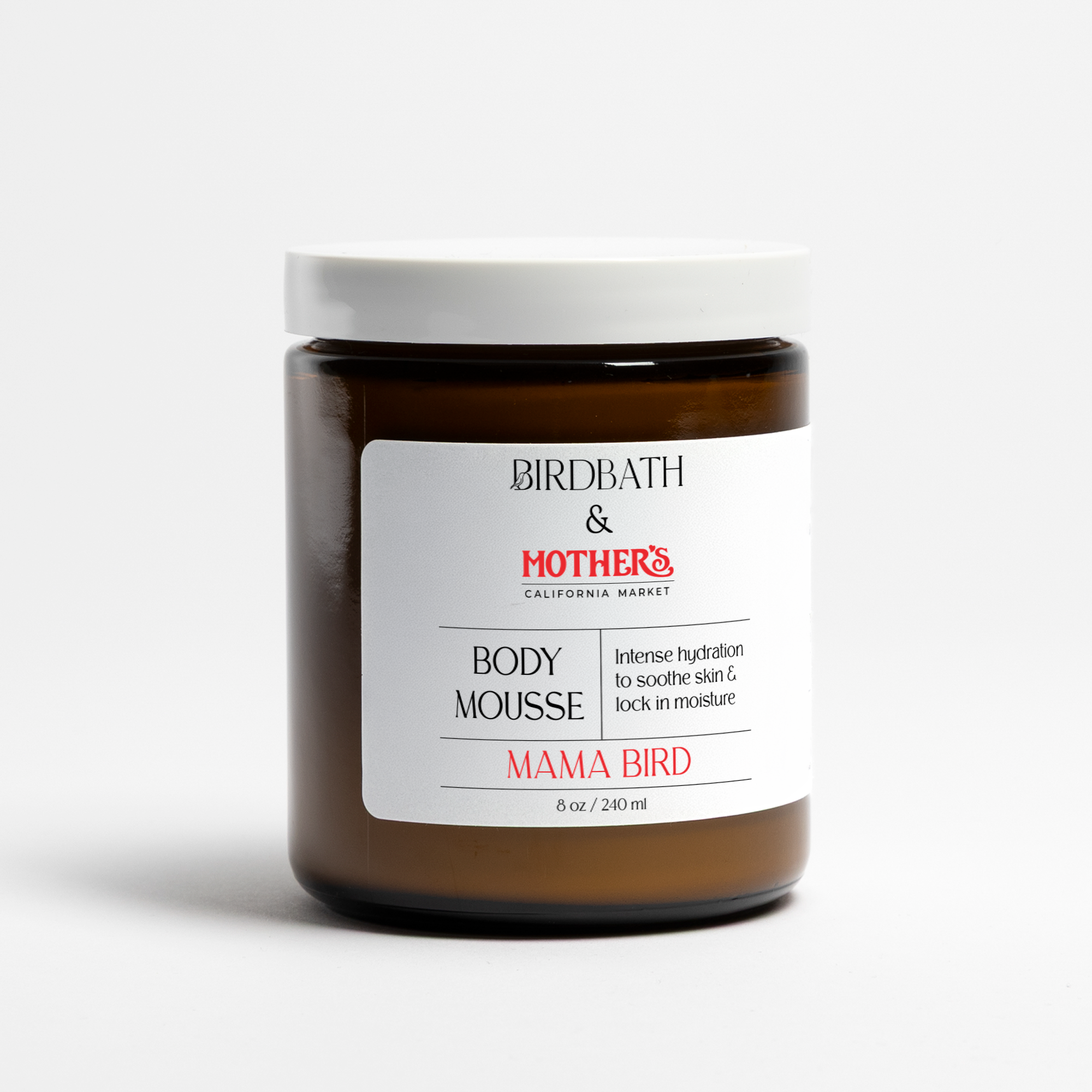 Birdbath Mama Bird Body Mousse in an amber jar on a white background.