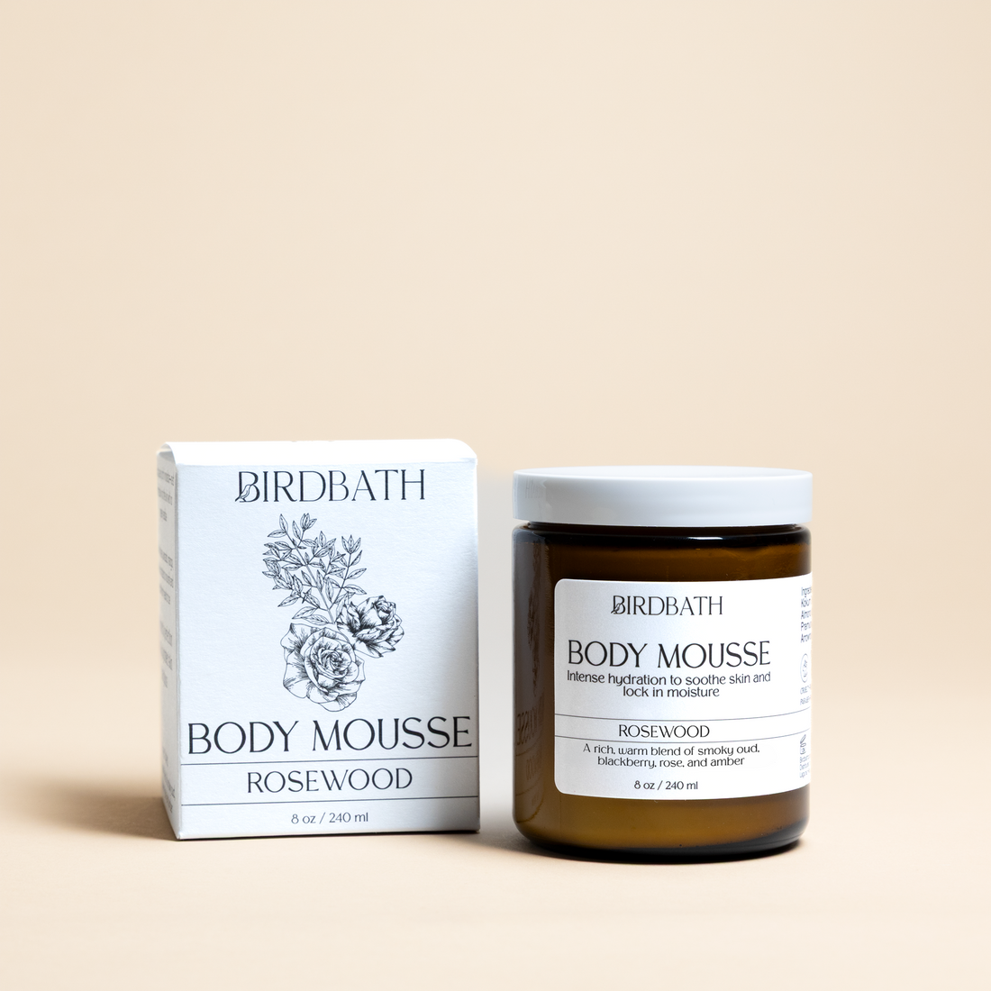Birdbath Rosewood Body Mousse jar with a white product box on a cream background.