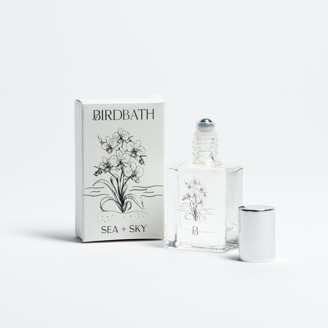 Birdbath Sea + sky Roll-on Perfume bottle with packaging on a white background.