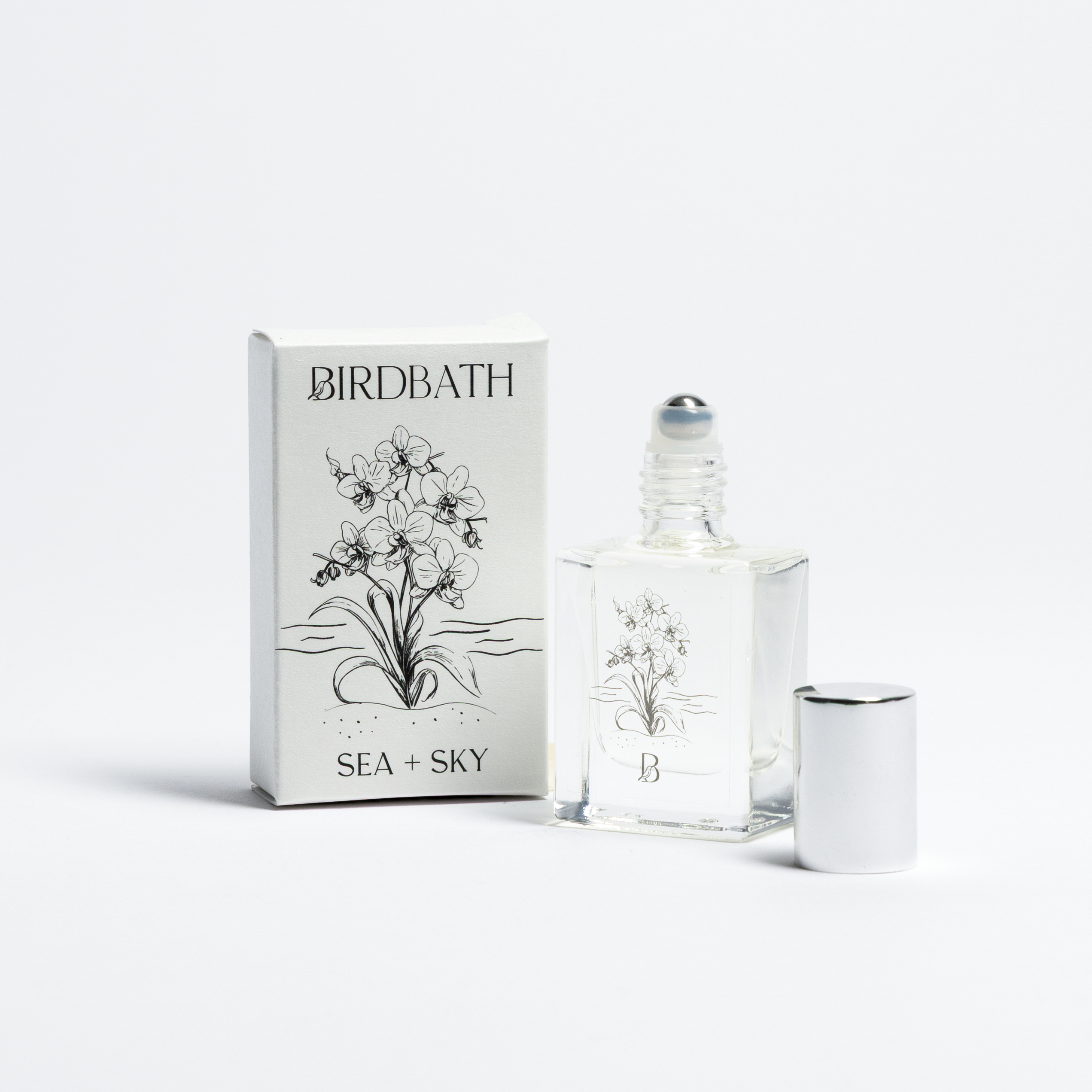 Birdbath Sea + sky Roll-on Perfume bottle with packaging on a white background.