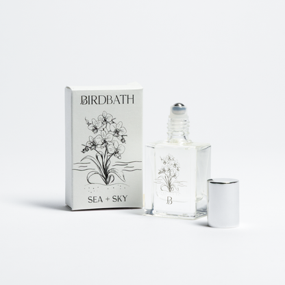 Birdbath Sea + sky Roll-on Perfume bottle with packaging on a white background.