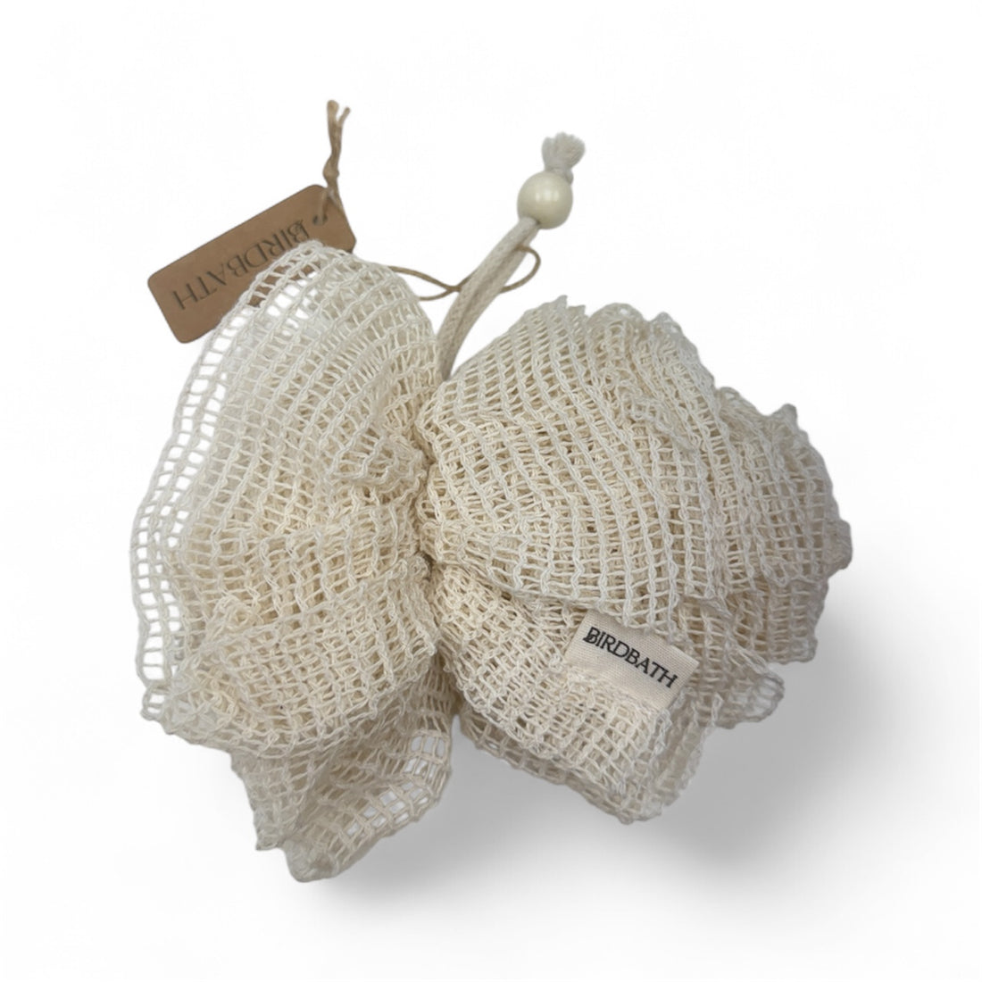 Natural sponge with a visible brand tag on a white background