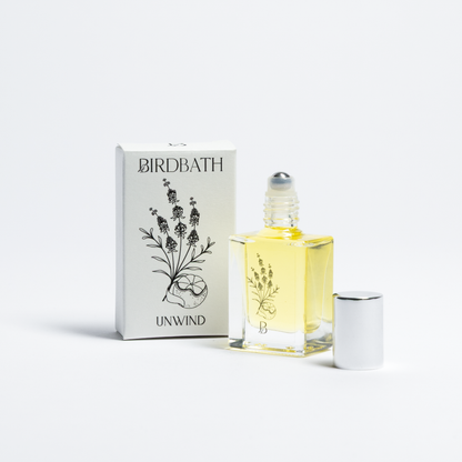 Birdbath Unwind essential oil bottle and packaging on a white background